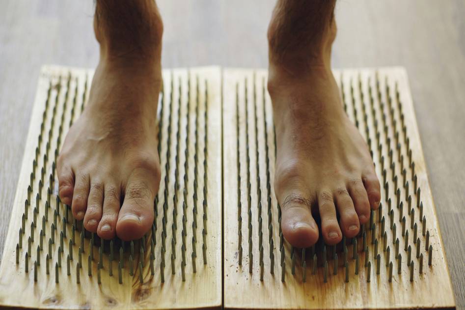 Woman receiving acupuncture treatment for weight loss in a calm, natural-lit wellness room with herbs and journals nearby